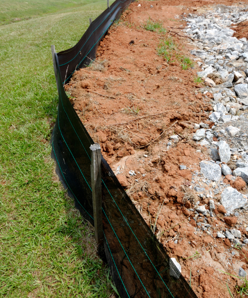 A section of a fence that has been dug into the ground